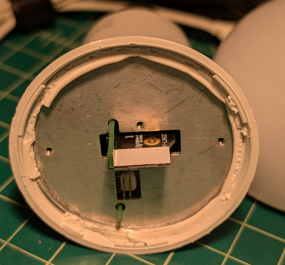LED daughter board removed. It reveals a solid metal plate preventing access to the mother board