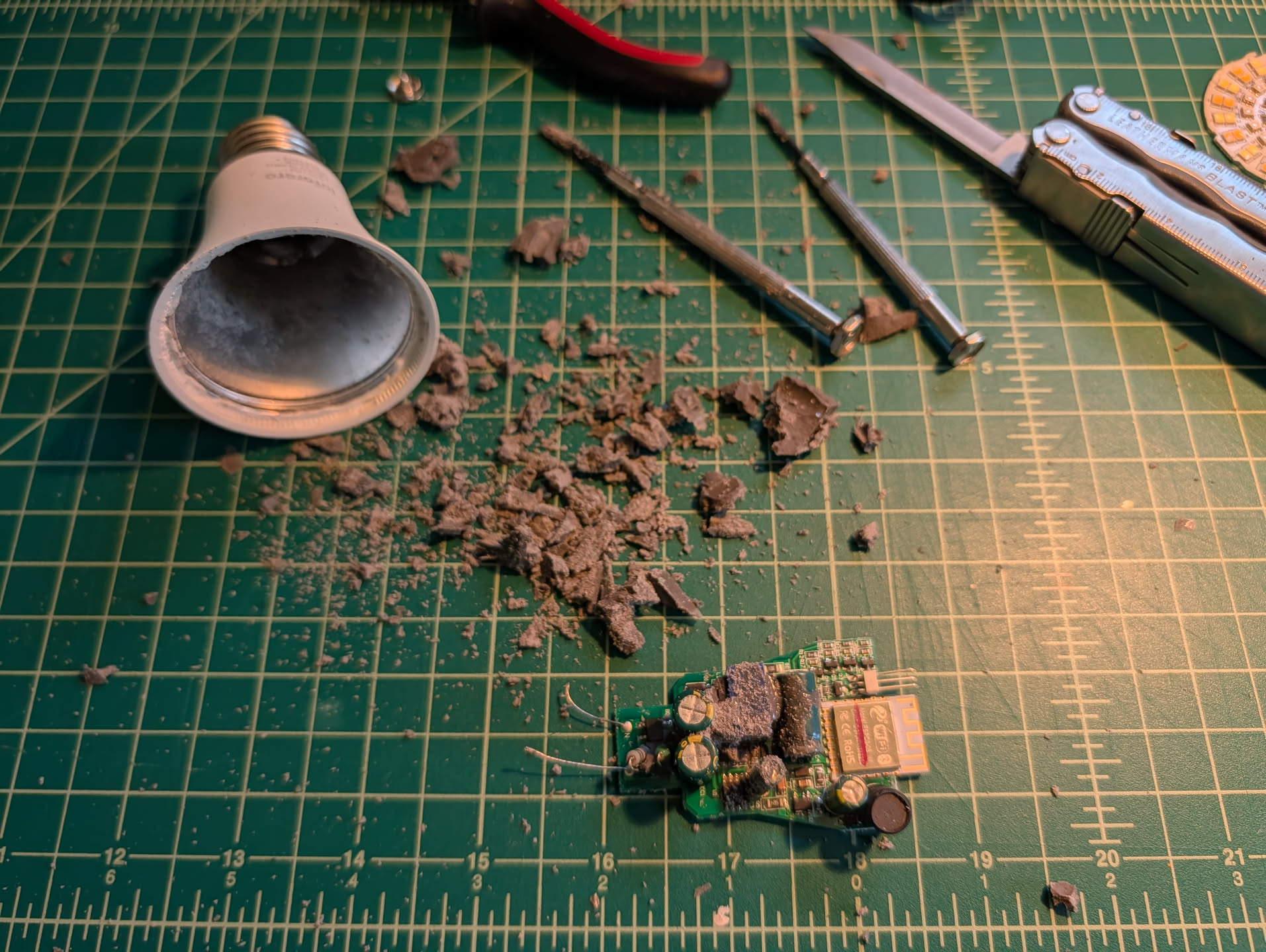 Image of the bulb housing, motherboard, and a bunch of chunks of potting compound