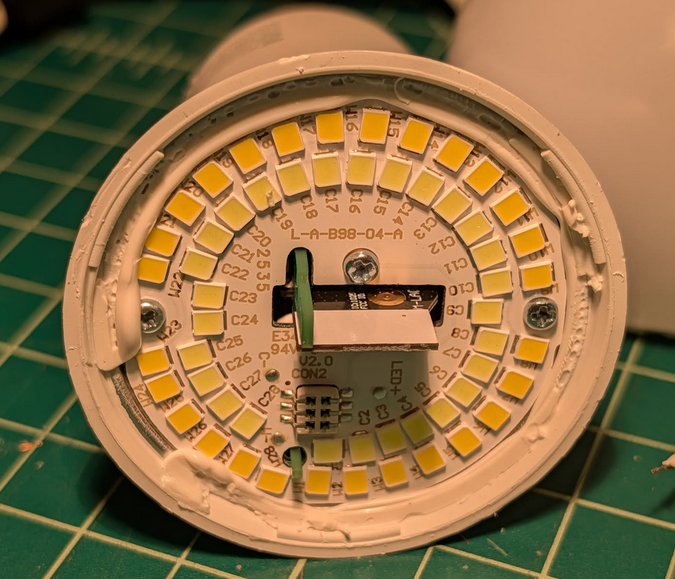 Photo of a light bulb with the top removed. A PCB can be seen with LEDs ringing the enge